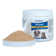 A white container has a label  "DocRoy's FeCease" with a dog & cat on it. The cap has a spoon in a pile of brown powder.