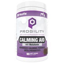 A white container with purple labels says "Progility Calming Aid with Melatonin". It contains soft chew bites for dogs.