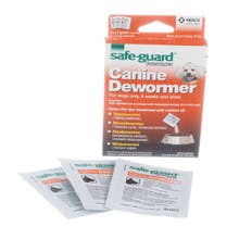 A box says "Canine Dewormer" with an image of a dog & packet of powder pouring into a dog bowl. There's 3 white packets too.